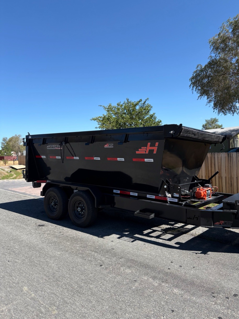 Longhorn dumpster trailer staged for a jobsite delivery